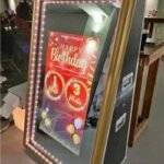 Classic Magic Mirror photo booth setup with elegant lighting and backdrop