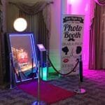 Magic mirror selfie booth with red carpet setup at indoor event venue